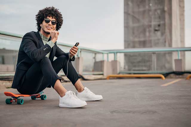 One-young-hipster-businessman-listening-music-on-the-smart-phone-in-the-city-1292436008_2125x1416