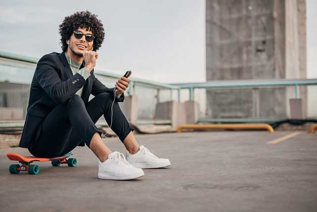 One-young-hipster-businessman-listening-music-on-the-smart-phone-in-the-city-1292436008_2125x1416